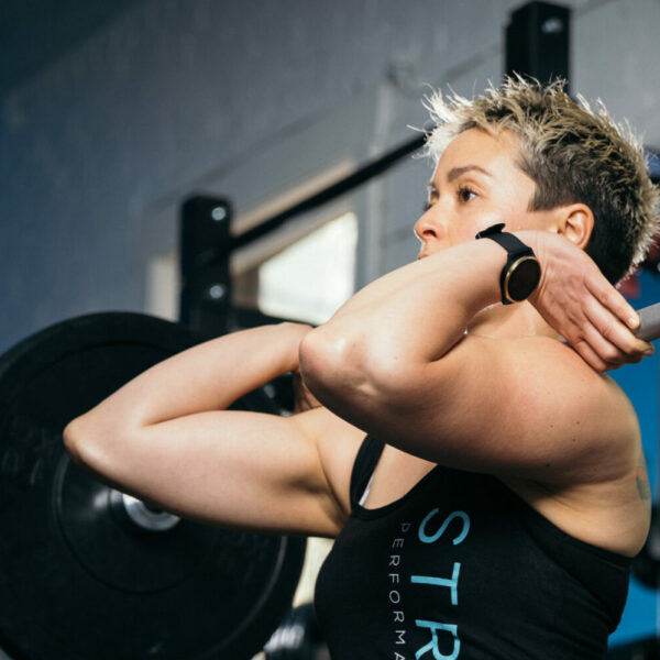 Cornelia Tan - personal trainer and instructor lifting weights