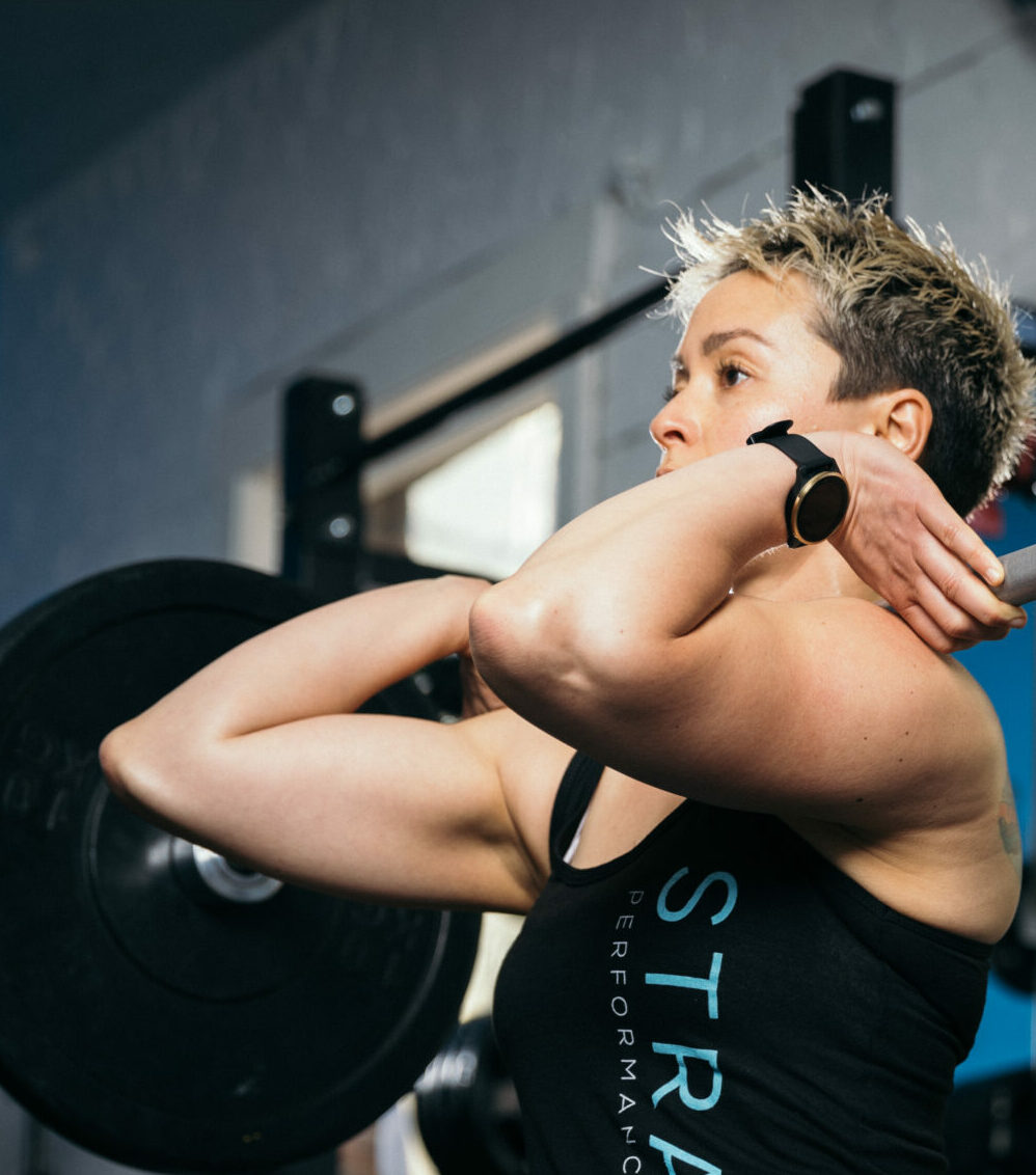Cornelia Tan - personal trainer and instructor lifting weights